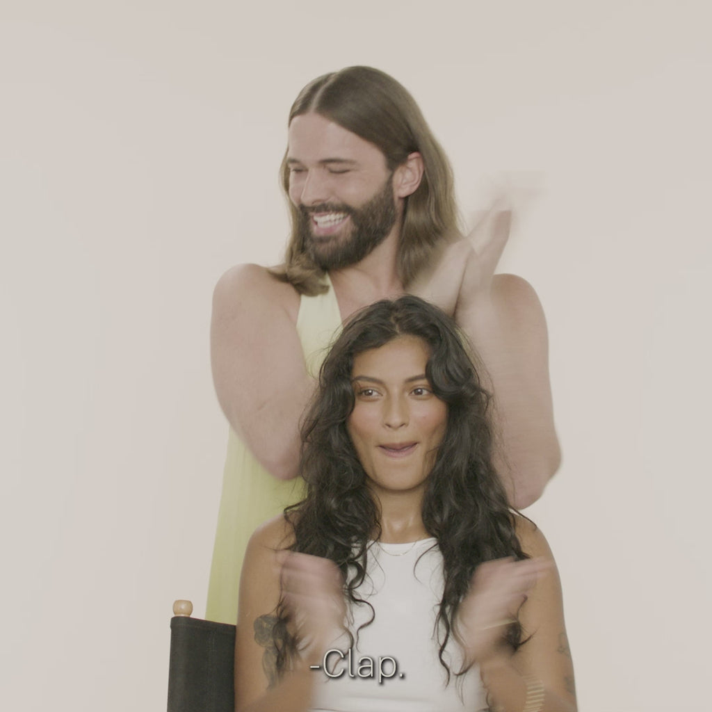 Jonathan Van Ness showing how to use Embody Volumizing Foam on model with long wavy dark hair